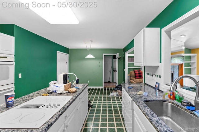 441 Parkview Dr, Detroit, MI 48214 - kitchen with a sink, white appliances, and white cabinetry