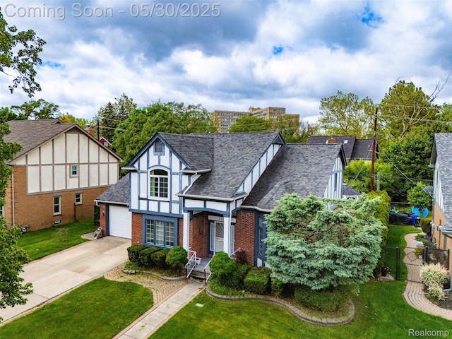 441 Parkview Dr, Detroit, MI 48214 - tudor house featuring brick siding, concrete driveway, and roof with shingles