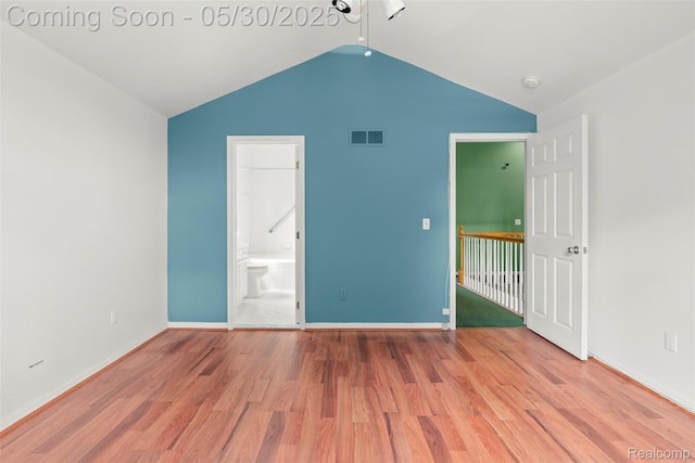 441 Parkview Dr, Detroit, MI 48214 - unfurnished bedroom with vaulted ceiling, wood finished floors, baseboards, and ensuite bath
