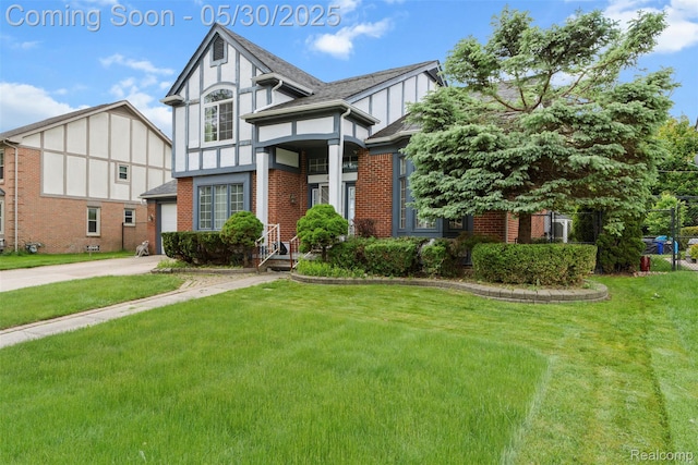 441 Parkview Dr, Detroit, MI 48214 - tudor home featuring a front lawn, brick siding, concrete driveway, a garage, and board and batten siding