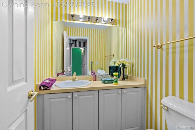 441 Parkview Dr, Detroit, MI 48214 - half bathroom featuring wallpapered walls, vanity, and toilet