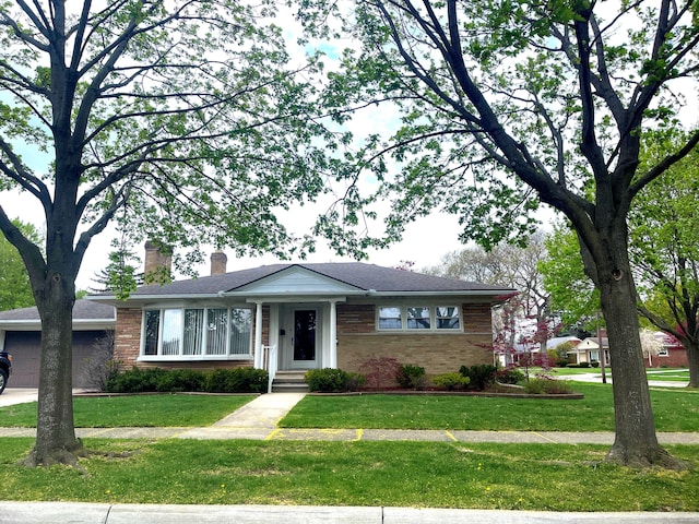 ranch-style house featuring brick siding, a front lawn, a chimney, and a garage