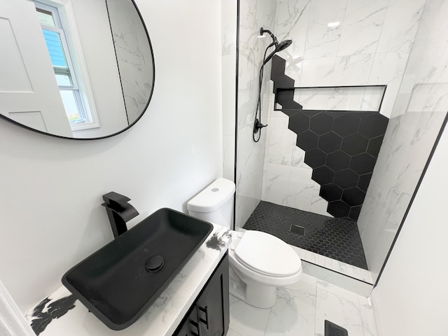 bathroom featuring a walk in shower, marble finish flooring, toilet, and vanity