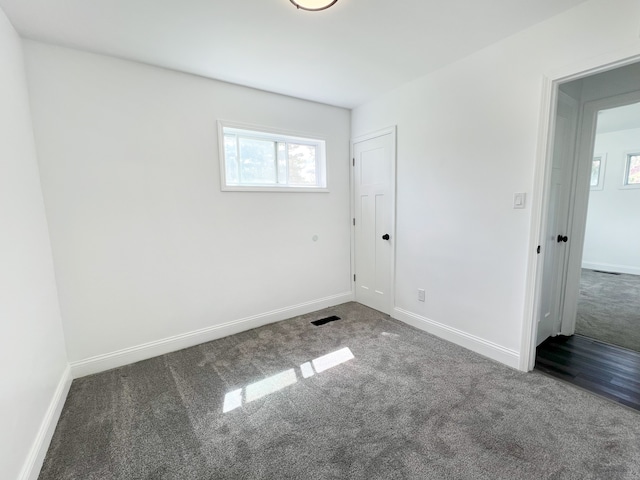 unfurnished room featuring carpet, healthy amount of natural light, and baseboards