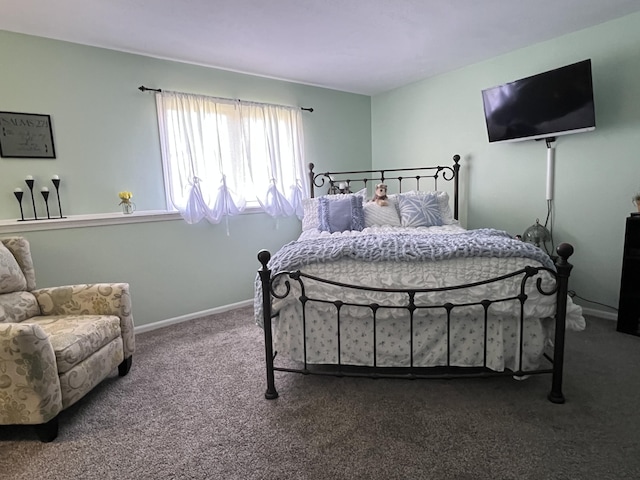bedroom featuring carpet and baseboards