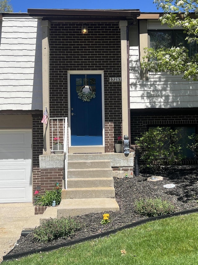 view of exterior entry with brick siding
