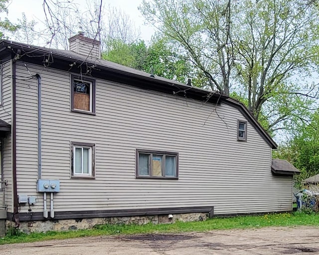 1123 Mills St, Kalamazoo, MI 49001 - view of property exterior featuring a chimney