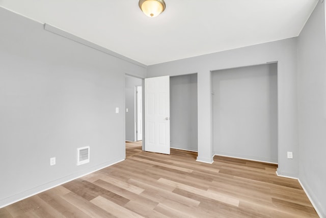 18250 Weaver St, Detroit, MI 48228 - unfurnished bedroom featuring light wood-style floors, baseboards, and two closets