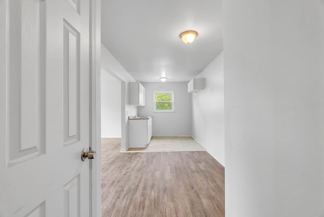 18250 Weaver St, Detroit, MI 48228 - spare room with light wood finished floors, baseboards, and a wall unit AC