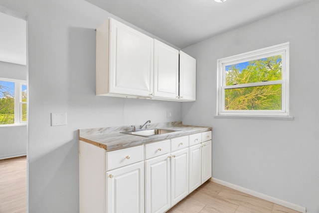 18250 Weaver St, Detroit, MI 48228 - clothes washing area featuring a sink, plenty of natural light, and baseboards