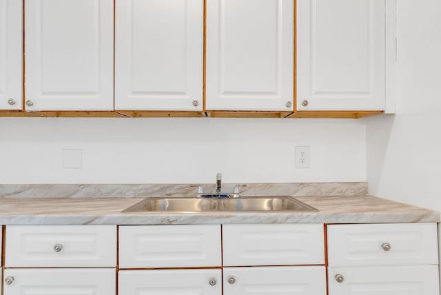 18250 Weaver St, Detroit, MI 48228 - kitchen featuring a sink, white cabinetry, and light countertops