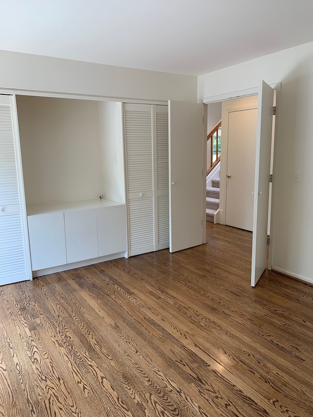 unfurnished bedroom featuring wood finished floors and a closet