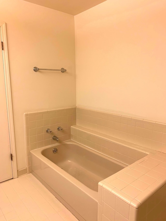 bathroom with a bath and tile patterned floors
