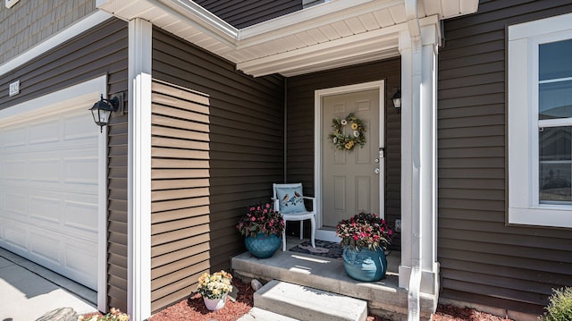 3242 Hill Hollow Ln, Howell, MI 48855 - view of exterior entry with a garage and a porch
