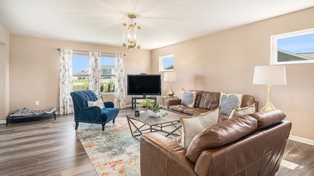 3242 Hill Hollow Ln, Howell, MI 48855 - living room featuring a chandelier, dark wood finished floors, and baseboards
