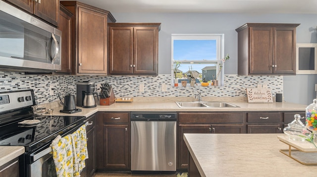 3242 Hill Hollow Ln, Howell, MI 48855 - kitchen featuring stainless steel appliances, a sink, backsplash, and light countertops