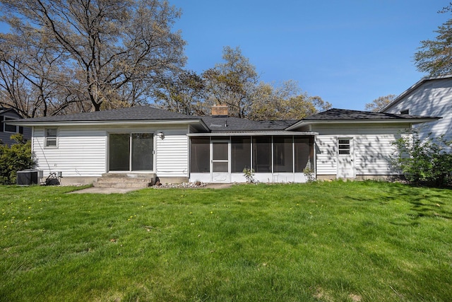 615 Garber Rd, North Muskegon, MI 49445 - rear view of property with a sunroom, a yard, central air condition unit, entry steps, and a chimney