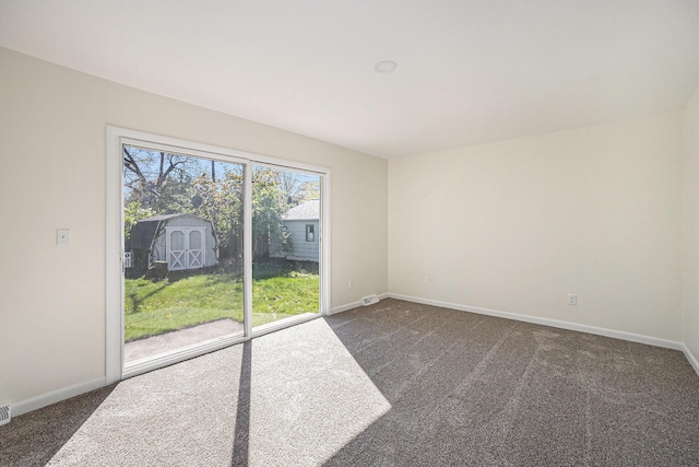 615 Garber Rd, North Muskegon, MI 49445 - unfurnished room with dark colored carpet and baseboards