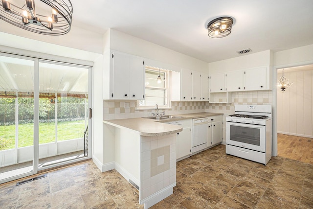 615 Garber Rd, North Muskegon, MI 49445 - kitchen featuring white appliances, a sink, a chandelier, backsplash, and stone finish flooring
