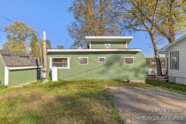 771 Sunny Trl, Greenville, MI 48838 - view of side of property featuring an outdoor structure and a storage unit