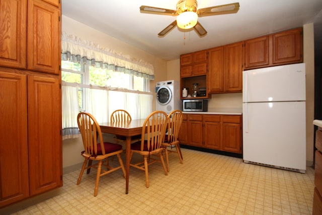 13687 W Tremblay Dr, Vicksburg, MI 49097 - dining room featuring estacked washer and dryer, a ceiling fan, and light flooring
