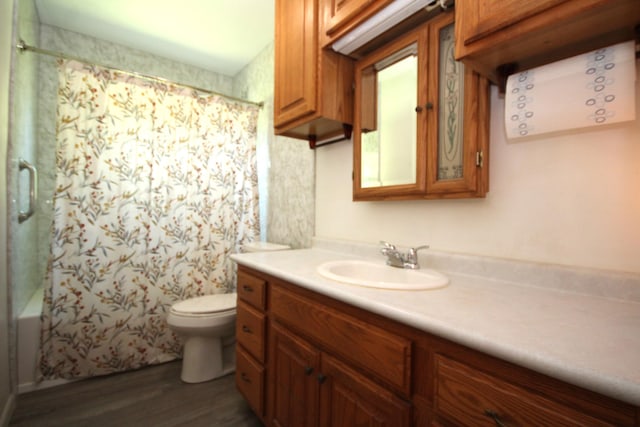 13687 W Tremblay Dr, Vicksburg, MI 49097 - full bath featuring wood finished floors, toilet, vanity, and shower / bath combination with curtain