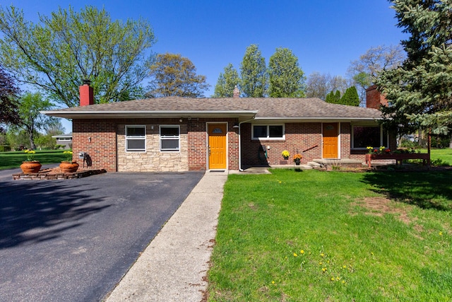 1119 Lambert Dr, Holly, MI 48442 - ranch-style house with a chimney, a front lawn, and asphalt driveway