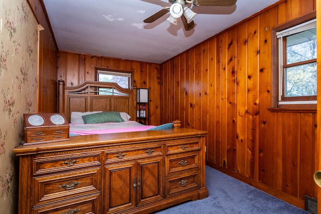 1119 Lambert Dr, Holly, MI 48442 - bedroom with carpet floors, wood walls, and a ceiling fan