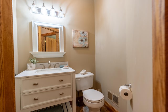 bathroom featuring toilet and vanity