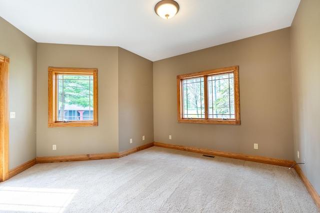 empty room with light carpet and baseboards