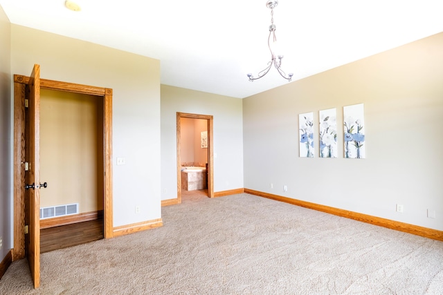 carpeted spare room featuring baseboards