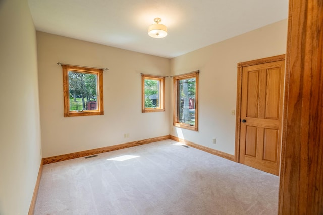 empty room with carpet floors and baseboards