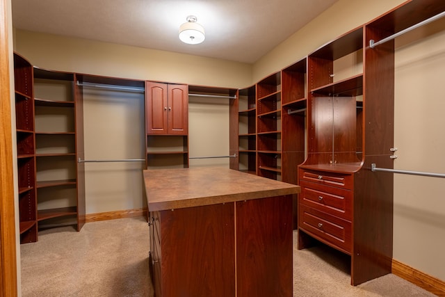 walk in closet featuring light colored carpet