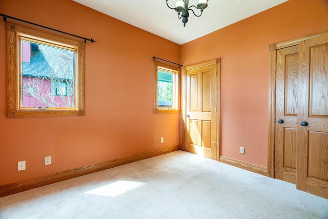unfurnished bedroom with carpet floors and baseboards