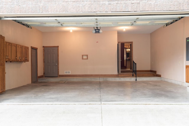 garage featuring a garage door opener and electric panel