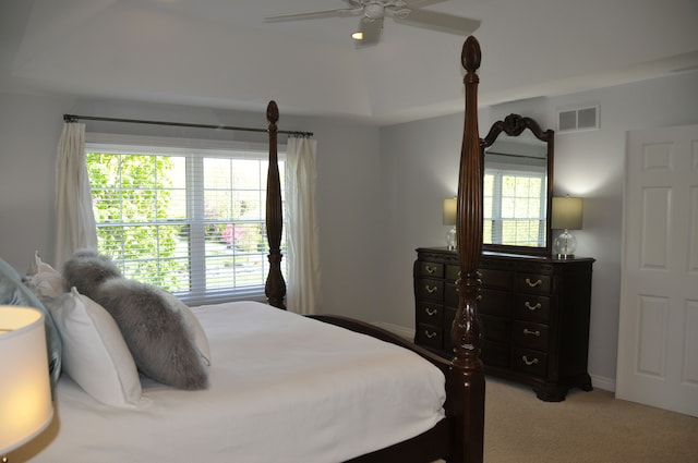 bedroom with light colored carpet and a ceiling fan