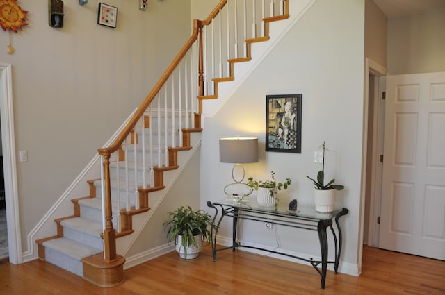 staircase with wood finished floors and baseboards