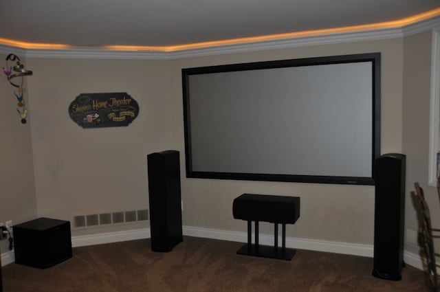 cinema featuring carpet floors, crown molding, and baseboards
