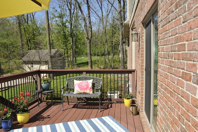 wooden deck featuring view of scattered trees