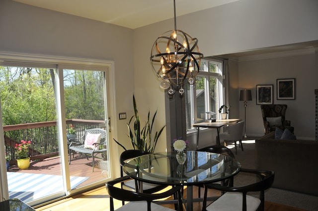dining room with a chandelier and crown molding