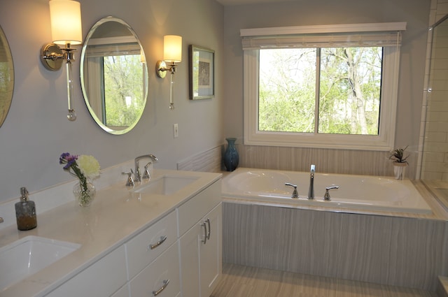 bathroom with a garden tub and double vanity