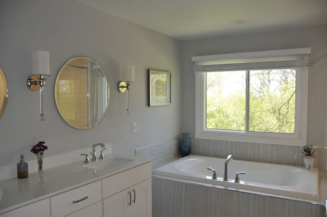 full bath with a bath and vanity