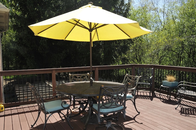 wooden terrace featuring outdoor dining space
