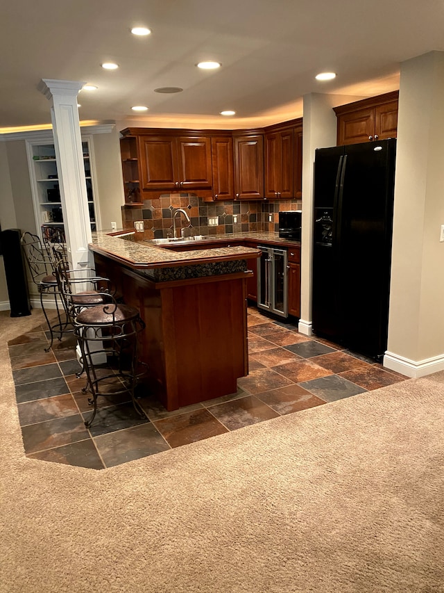 320 N Berkshire Rd, Bloomfield Hills, MI 48302 - kitchen featuring black refrigerator with ice dispenser, recessed lighting, a kitchen bar, open shelves, and a peninsula