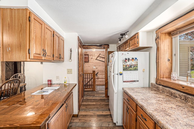 3771 E Loop Rd, Hesperia, MI 49421 - kitchen featuring freestanding refrigerator, dark wood-style floors, and brown cabinets