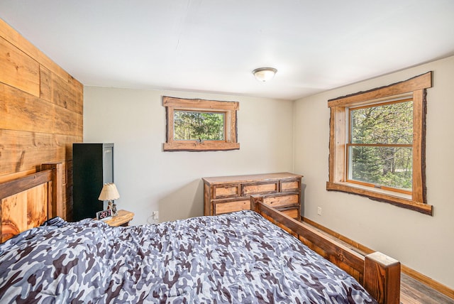 3771 E Loop Rd, Hesperia, MI 49421 - bedroom featuring wood finished floors and baseboards