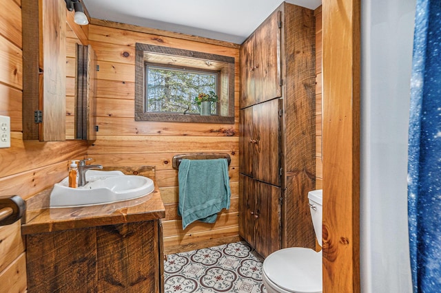 3771 E Loop Rd, Hesperia, MI 49421 - half bathroom with toilet, vanity, and wood walls