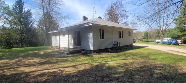 3771 E Loop Rd, Hesperia, MI 49421 - view of property exterior featuring a chimney and a yard
