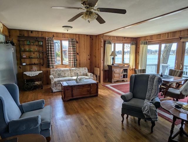 63568 Zabel Shores Rd, Sturgis, MI 49091 - living area with wooden walls, a water view, a ceiling fan, and wood finished floors