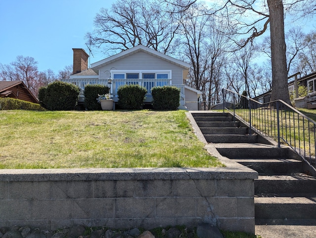 63568 Zabel Shores Rd, Sturgis, MI 49091 - view of front of home featuring a front yard, a chimney, and stairs